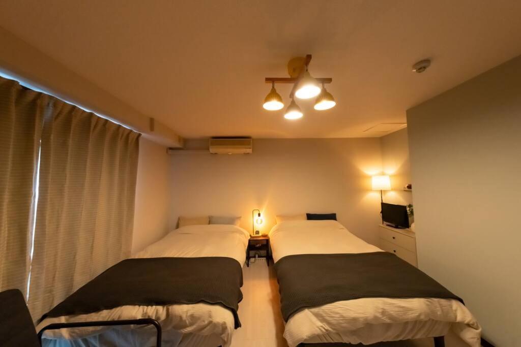難波駅、道頓堀のそばでシンプルステイ　ベッド3台のお部屋 Apartment
